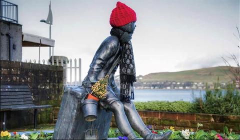 Annie Kempock Statue with hat scarf and flowers