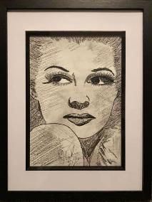 Framed pencil drawing of a woman's face and shoulder