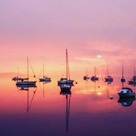 Sail boats on the lake at sunset